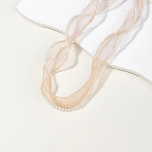 Champagne sheer chiffon ribbon with delicate pearl trim for hair bows and floral gift wrapping.