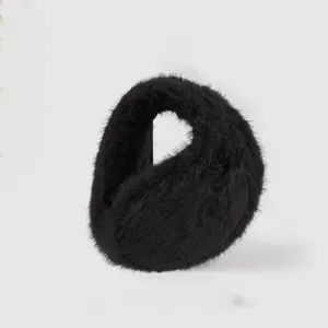 Close-up detail view of black plush earmuffs, fluffy winter ear warmers for cold weather use.