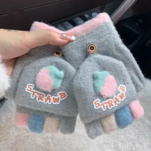 Close-up detail of cute winter knit half-finger convertible gloves with strawberry decor.