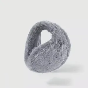 Close-up detail of soft grey plush winter earmuffs, fluffy cozy cold-weather ear warmer accessory.