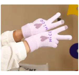 Detail view of winter warm knitted touch screen gloves for women with cute heart and letter design.