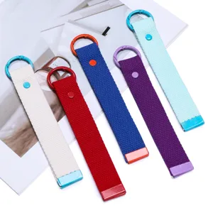 Close-up detail of colorful woven webbing keychains with metal rings in various vibrant colors.