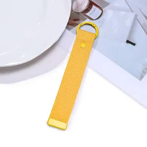 Yellow woven strap keychain with metal ring, stylish bag charm and backpack pendant.
