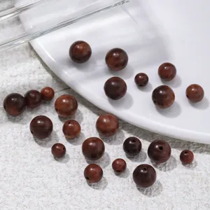 Close-up detail of natural wood loose beads, drilled round beads for DIY jewelry making.