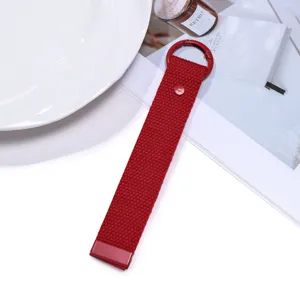 Red woven lanyard keychain detail shot, minimalist fabric strap bag accessory for daily use.