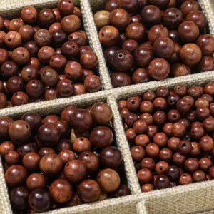 Close-up view of natural wood beads showing exquisite grain and multiple sizes for crafts.