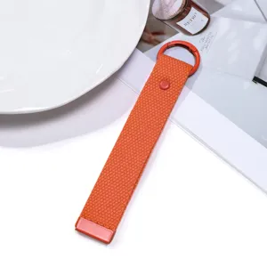 Orange woven lanyard keychain, minimalist portable bag pendant and backpack accessory.