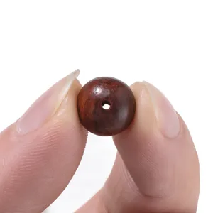 Wood bead detail close-up showing natural grain texture and central hole drilling.