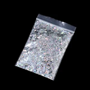 Close-up view of holographic nail art glitter sequins in a clear bag, sparkling and vibrant.