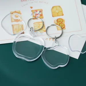 Clear acrylic blank photo frame keychain detail, apple shape with metal clasp, DIY gift accessory.
