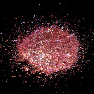 Macro detail shot of sparkling holographic pink glitter flakes, perfect for nail art dust.