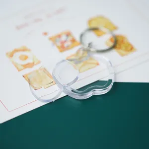 Close-up detail of clear blank acrylic keychain photo frame with metal clasp for DIY gifts.