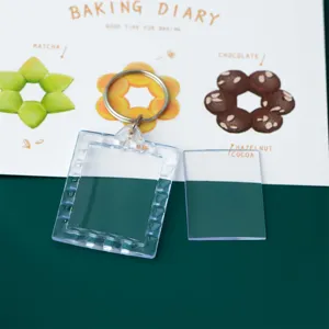 Close-up detail of clear acrylic photo frame keychain blank with metal clasp and insert card.