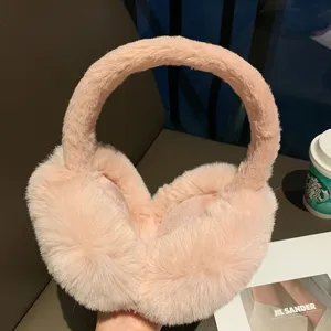 Detailed view of winter pink plush earmuffs, soft and thick fluffy material for cold weather.