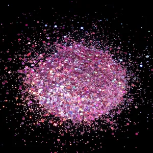 Close-up detail of sparkling pink holographic glitter flakes, perfect for nail art designs.