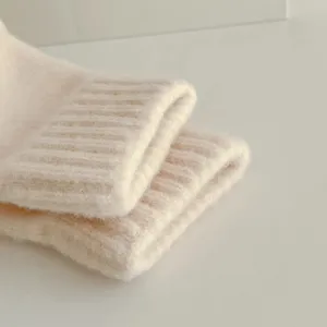 Knit gloves detail shot, cozy fuzzy texture, ribbed cuff design, warm winter accessory.
