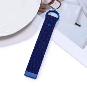 Detailed view of the dark blue woven keychain strap with metal ring and snap button.