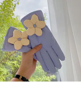 Close-up view of winter warm down gloves detail featuring 3D cream flower decoration.