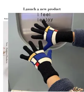 Detailed view of winter warm knit fleece gloves with abstract geometric color block pattern.