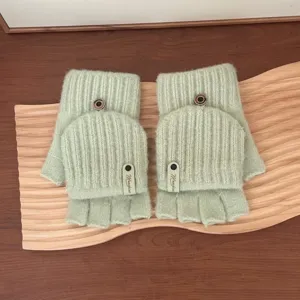 Close-up detail of women's winter warm knit convertible half-finger gloves in light green.