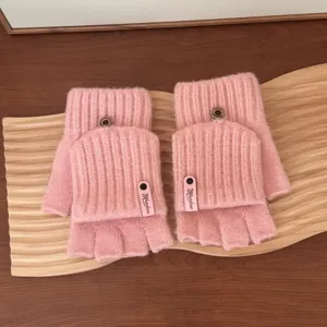 Detailed shot of pink knitted fingerless gloves with flip covers and cute buttons.