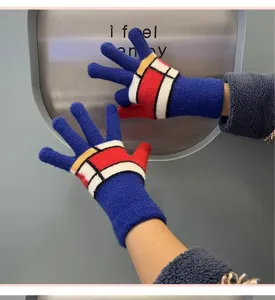 Close-up of winter knitted gloves with geometric color blocks, warm and comfortable detail view.