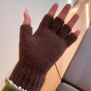 Brown knitted half-finger gloves for winter warmth, soft plush knit material detail view.