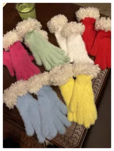 Detail view of multi-color plush winter gloves featuring cozy fluffy cuffs and warm knit design.