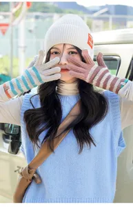Detailed view of women winter knitted striped fingerless gloves outdoor warm thermal wear stylish