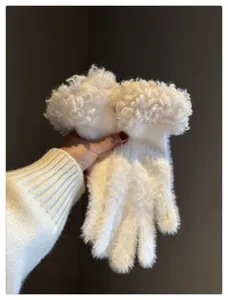 Close-up detail of fluffy plush winter gloves with curly cuffs, soft and warm knit fabric.