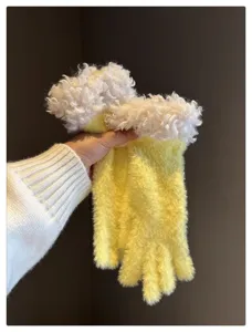 Detailed view of winter warm plush yellow gloves with fluffy white curly cuffs close up.