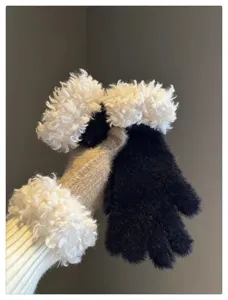 Close-up detail of winter plush warm gloves with fluffy white cuffs soft texture.