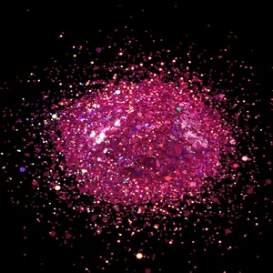 Macro detail shot of sparkling pink hexagonal nail art glitter sequins and powder.