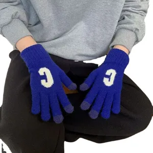 Cozy blue knit gloves for women, featuring a cute white letter C design and touch screen fingertips.