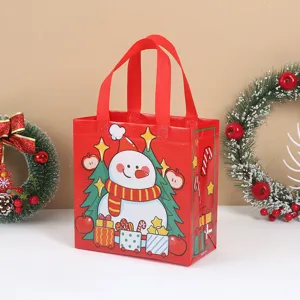 Red Christmas non-woven tote bag with cute snowman and tree design for holiday gift packaging.
