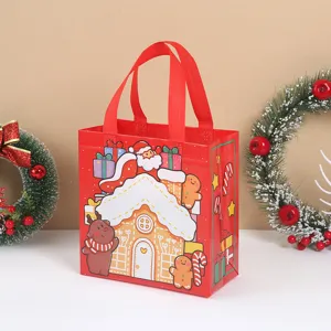 Red Christmas non-woven tote bag with gingerbread house and Santa design for holiday gifts.