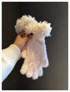 Close-up of plush winter gloves with fluffy cuffs, showcasing soft texture and cozy warmth design.