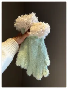 Close-up detail of winter plush gloves, mint green knit with fluffy white faux fur cuff.