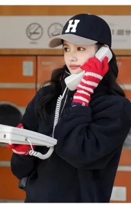 Knit striped warm gloves detail shot, cozy winter red and white design for outdoor wear.