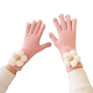 Cute pink knitted touchscreen gloves for women featuring a sweet floral wrist design for winter warmth.