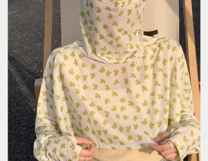 Detailed view of the summer UV protection face cover and sun shawl with green bird print design.