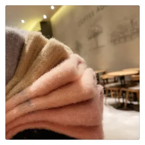 Winter fuzzy knit gloves detail showing soft plush texture, warm multi-color options for women.