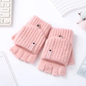 Close-up detail of pink knitted convertible fingerless gloves with cozy wool texture.