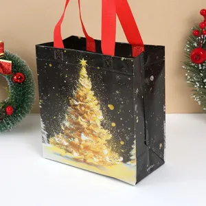 Thickened black non-woven Christmas gift bag with gold tree print and red handles for holidays.