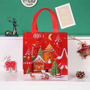 Christmas non-woven gift bag with festive Santa castle print, red handles for holiday packaging.