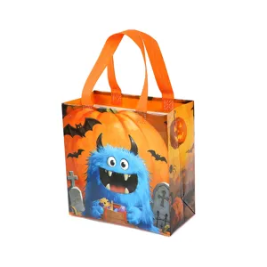Halloween candy non-woven gift bag with cute blue monster and pumpkin design for parties.