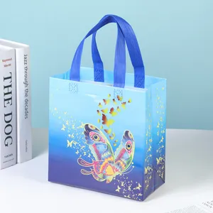 Blue gradient non-woven gift bag with butterfly print reusable shopping tote for party favors.