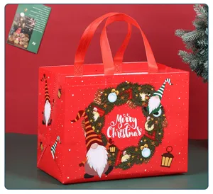 Detail shot of a large red non-woven Christmas gift bag with gnome and wreath design.