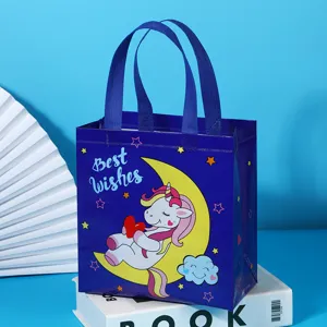 Blue non-woven gift bag with cute unicorn and moon design, perfect for party favors and shopping.