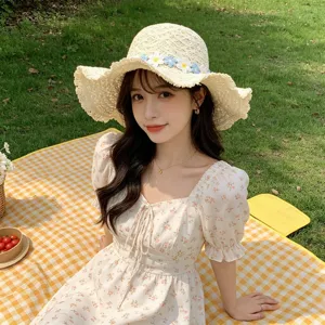 Straw sun hat with cute floral band, outdoor beach hat for women, perfect for summer days.